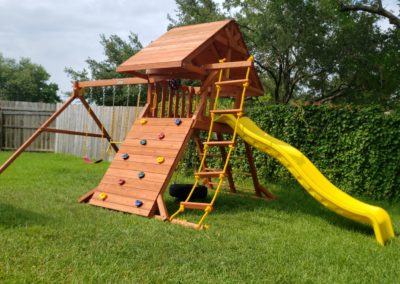 Farm-and-yard-tx-Toucan-Playcenter-w_-wood-roof-and-Yellow-Wave-Slide-Customer-4