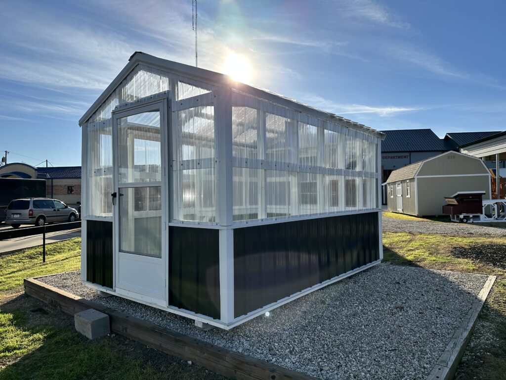 Black siding and white trim on the exterior of this 8x12 A-Frame Greenhouse 