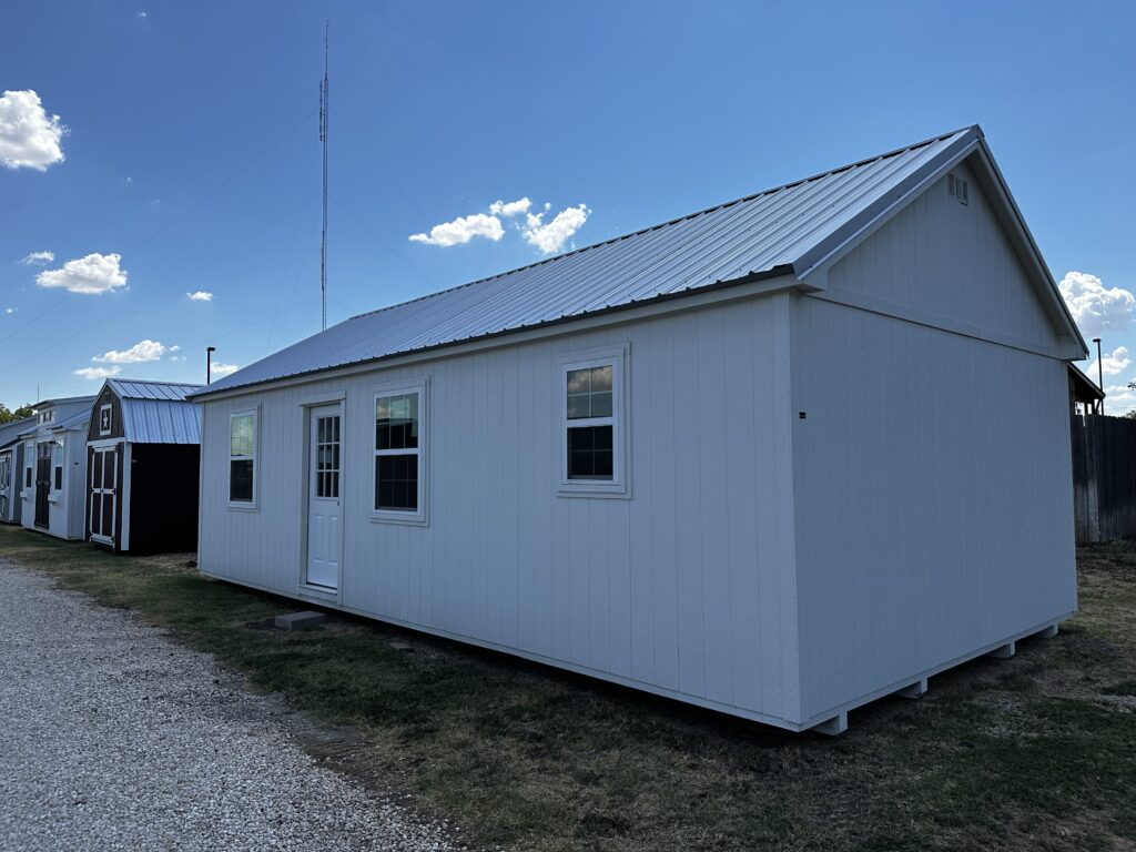 White siding and white trim on exterior of this 16x32 Chalet Tiny Home Shell