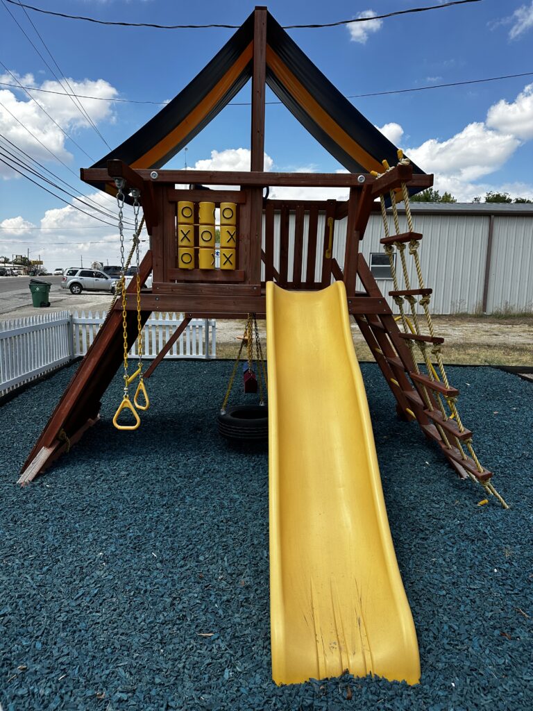Yellow Wave Slide installed on the end of the Parrot Island Playcenter 